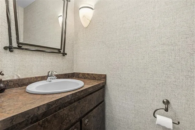 a bathroom with a sink vanity and a mirror