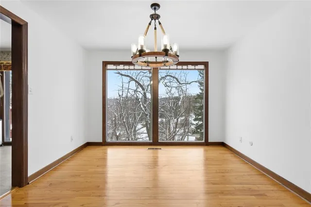 a view of wooden floor and windows in a room