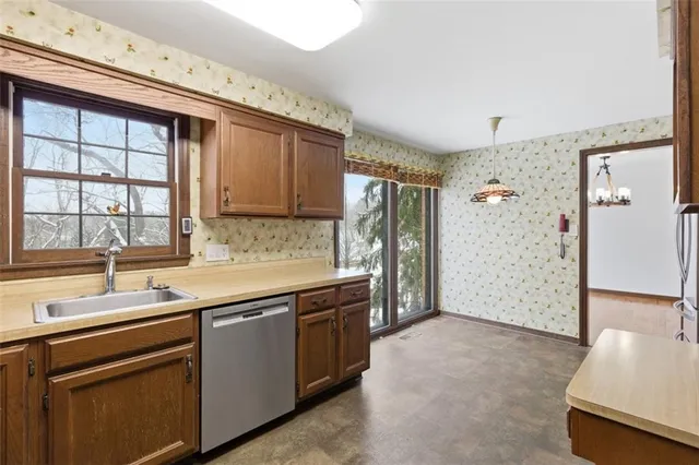 a kitchen that has a sink and a stove in it