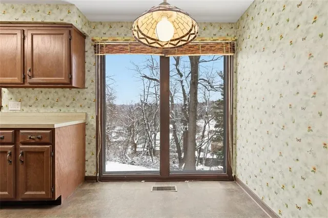 a view of a door with wooden floor and a sink