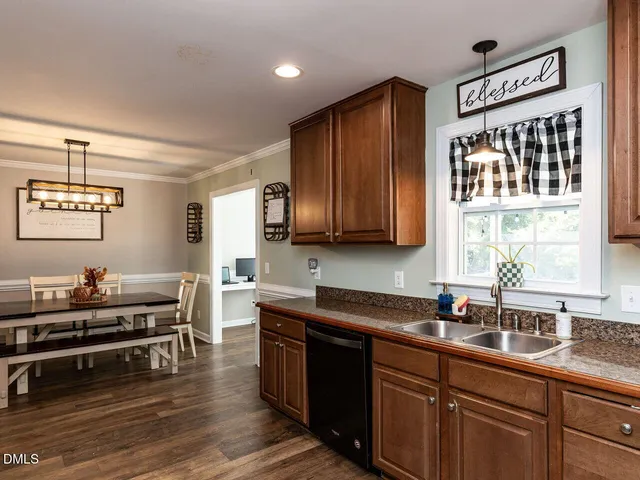 a kitchen with lots of counter top space and wooden floor