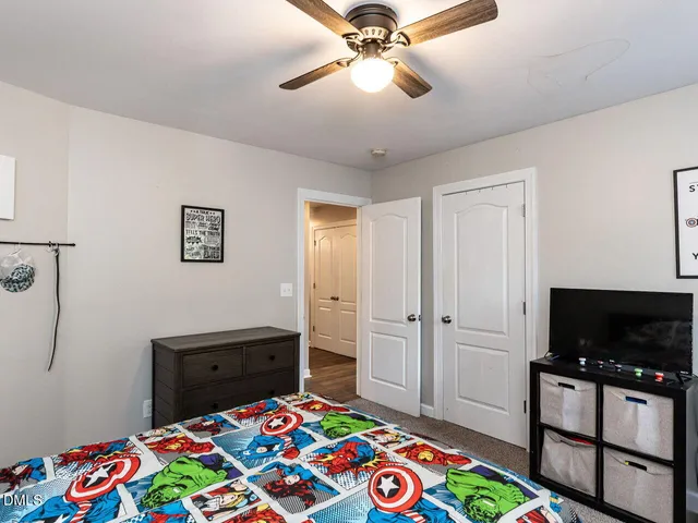 a bedroom with a bed and flat screen tv