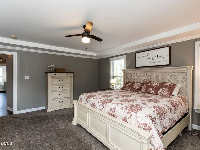 a bedroom with a bed and a ceiling fan