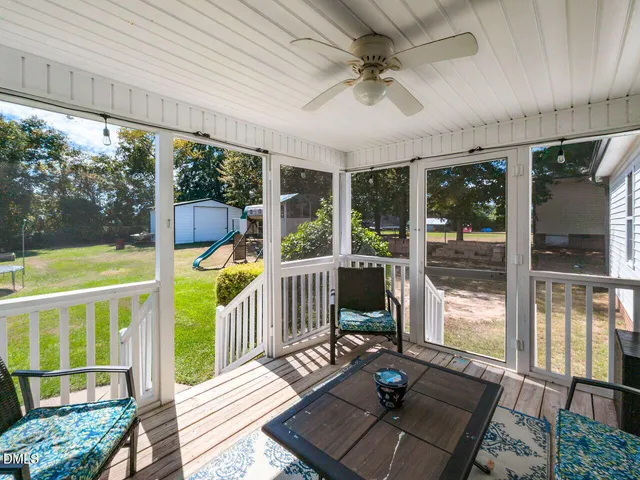 a view of a porch with wooden floor and furniture