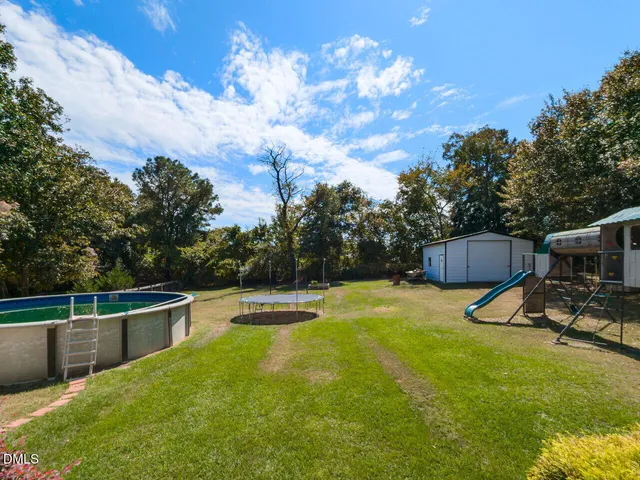 a view of a swimming pool with a yard