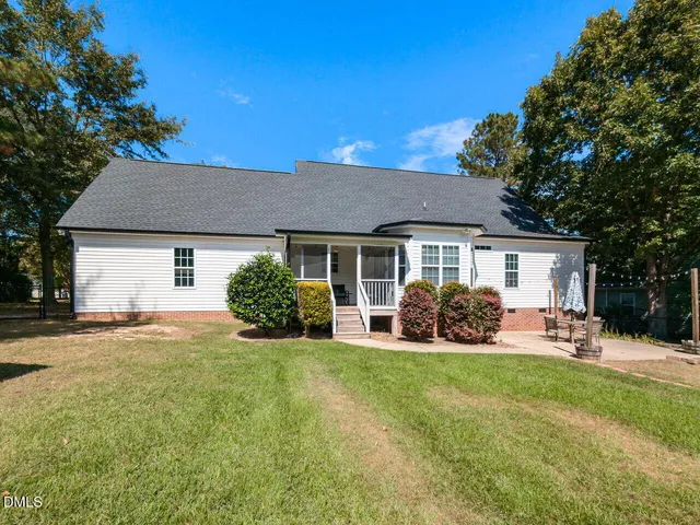 a view of a house with a yard and sitting area