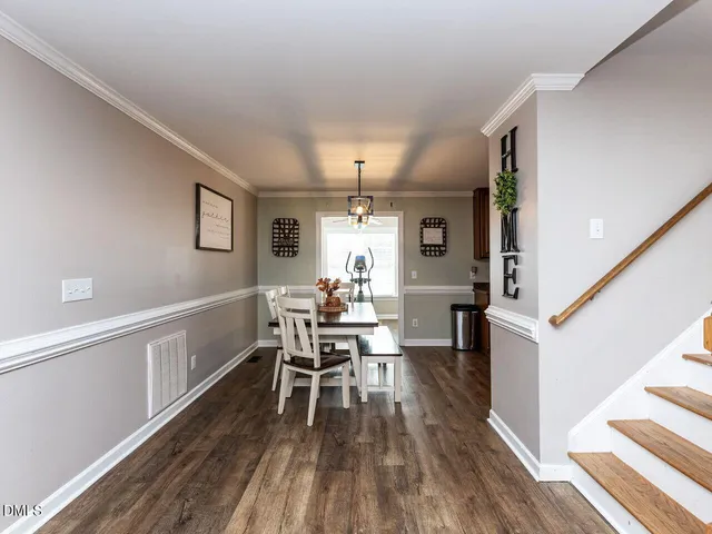 a dining room with furniture and wooden floor