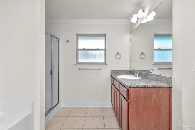 a bathroom with a granite countertop sink a mirror and a vanity