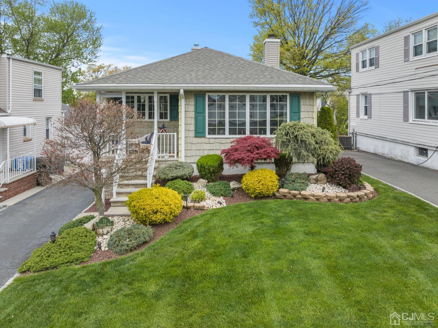 78 Highfield Road Colonia, NJ 07067 - Photo 1 of 8 a front view of a house with a garden and porch
