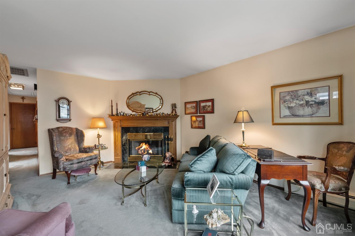78 Highfield Road Colonia, NJ 07067 - Photo 6 of 8 a living room with furniture and a fireplace