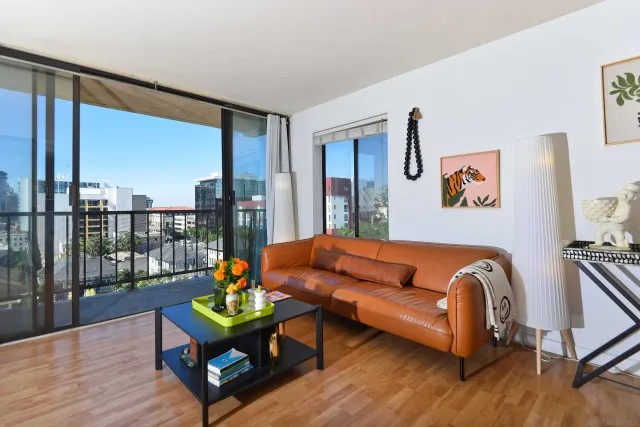 a blue couch sitting in a living room next to a window