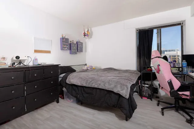 a bedroom with a bed and a dresser