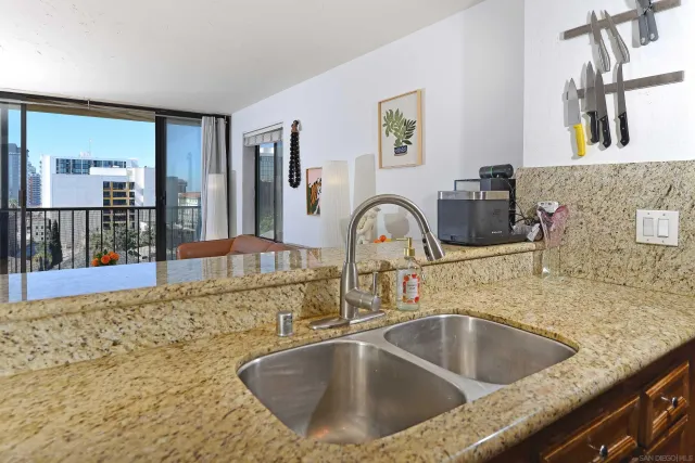 a kitchen with sink and mirror