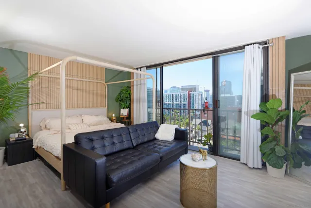 a living room with furniture and a large window with outer view