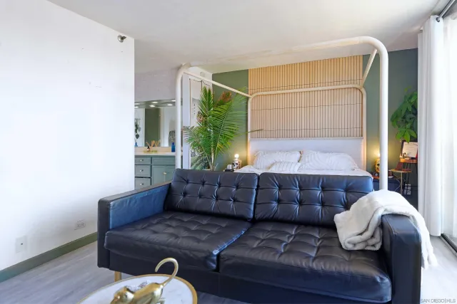 a living room with furniture and a potted plant