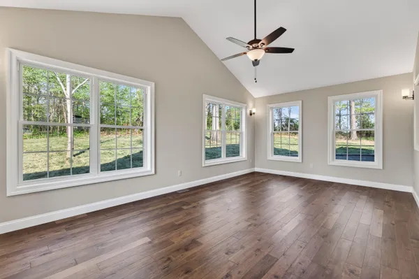 a kitchen with stainless steel appliances granite countertop a refrigerator sink and wooden floor