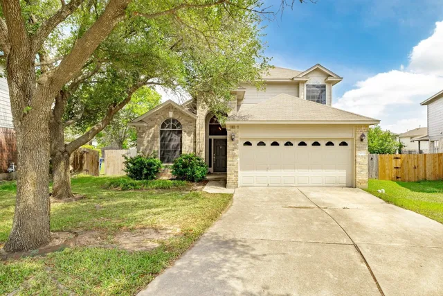 a front view of a house with a yard and garage