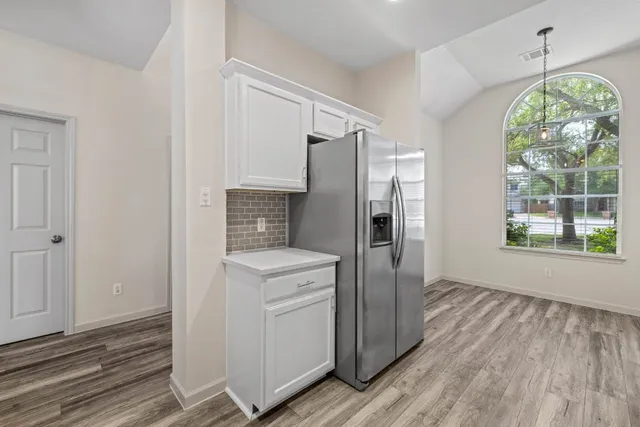 a kitchen with a refrigerator a washer and dryer