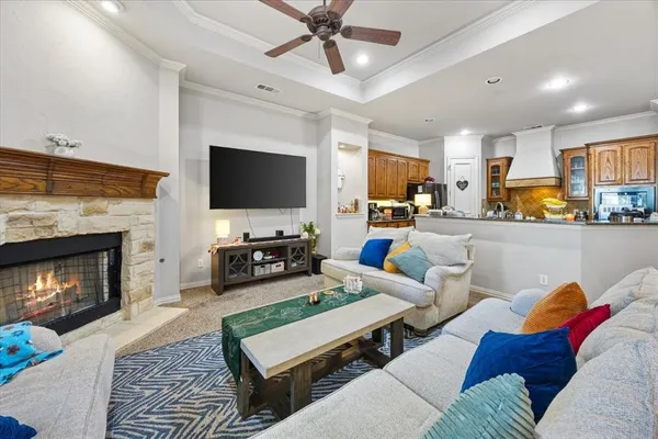 a living room with furniture a flat screen tv and a fireplace