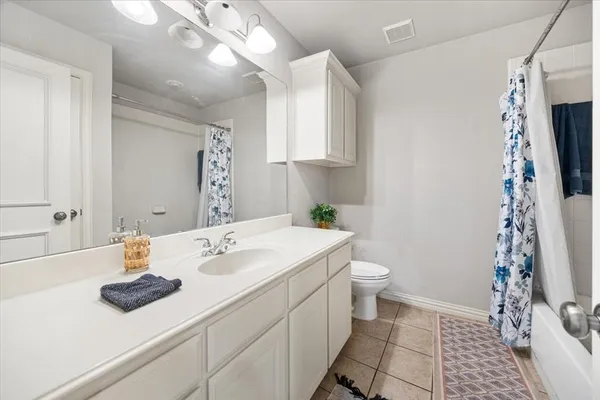 a bedroom with a bed and a table chair