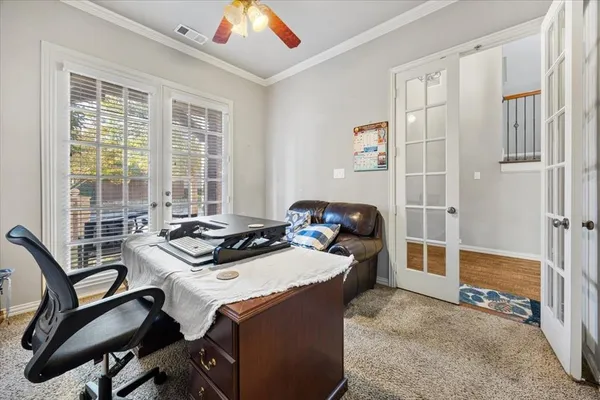 a work room with furniture a large window and gym equipment