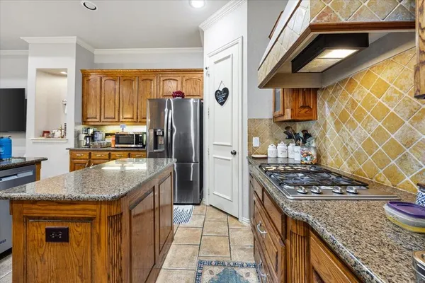 a kitchen with stainless steel appliances granite countertop a stove and refrigerator