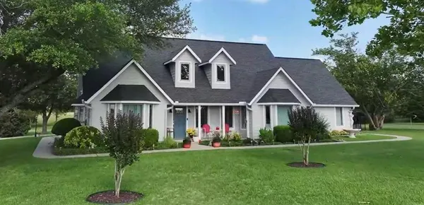 a front view of house with yard and green space