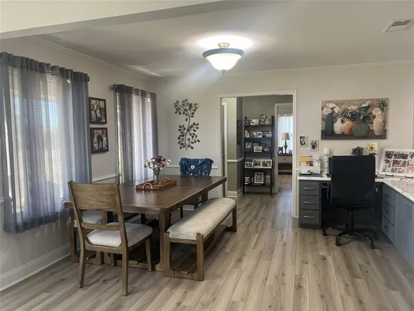 a view of a dining room with furniture and wooden floor