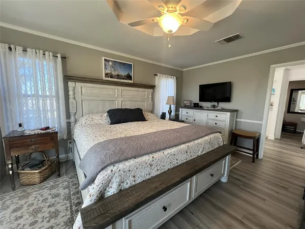 a spacious bedroom with a bed and a chandelier