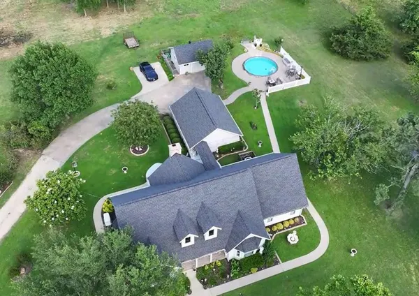 an aerial view of a house with garden space and street view