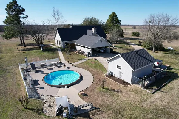 a view of a backyard with furniture and a patio