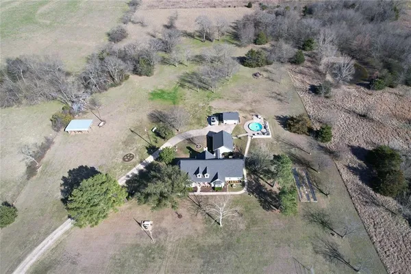 an aerial view of a house with a yard