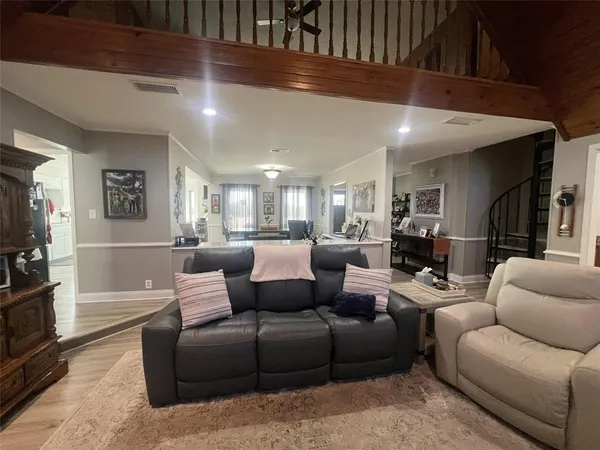 a living room with furniture white walls and a flat screen tv