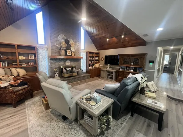 a living room with furniture a fireplace and a flat screen tv