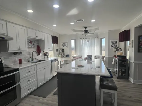 a kitchen with sink stove and refrigerator