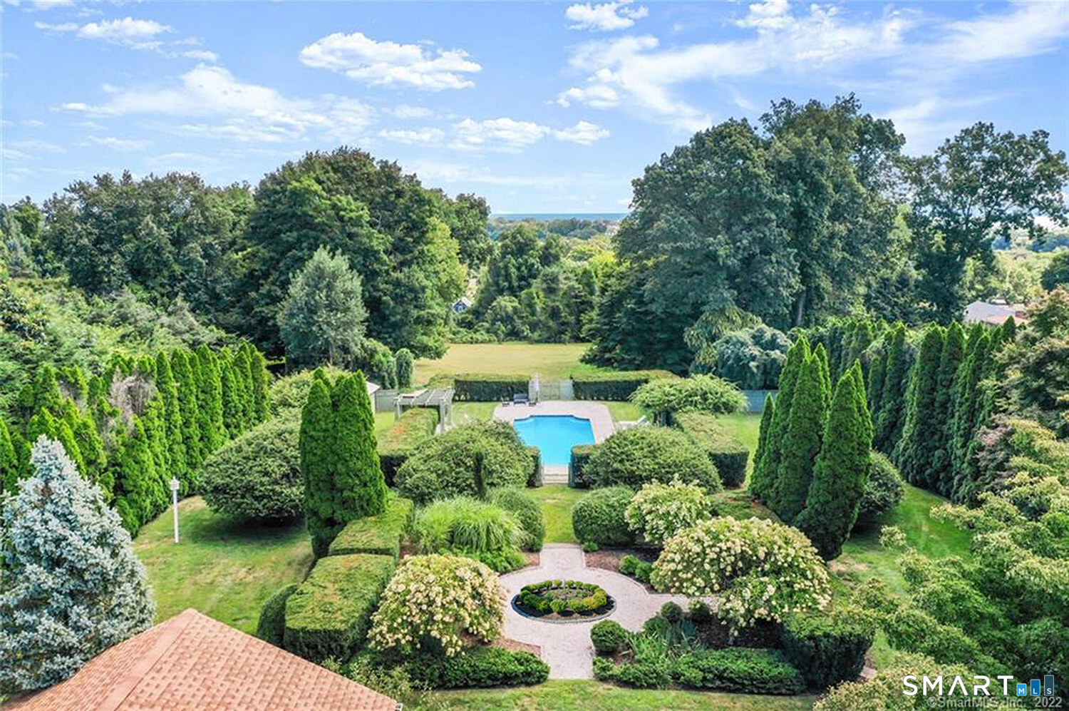 775 Sasco Hill Road Fairfield, CT 06824 - Photo 36 of 36 a view of a garden with plants and a bench