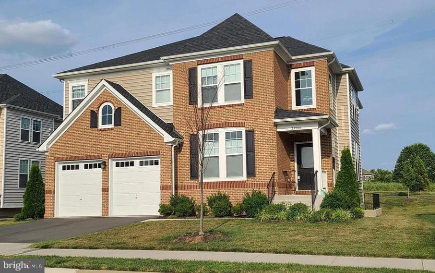 24800 Beardgrass Place Aldie, VA 20105 - Photo 1 of 25 a front view of a house with a yard