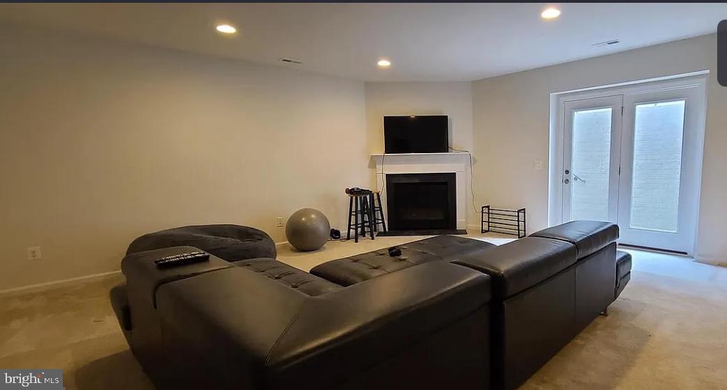 24800 Beardgrass Place Aldie, VA 20105 - Photo 13 of 25 a living room with furniture a fireplace and a flat screen tv
