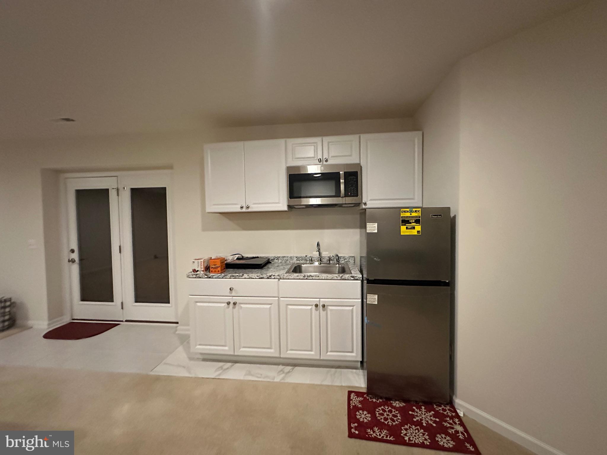 24800 Beardgrass Place Aldie, VA 20105 - Photo 21 of 25 a kitchen with stainless steel appliances a refrigerator sink and stove top oven