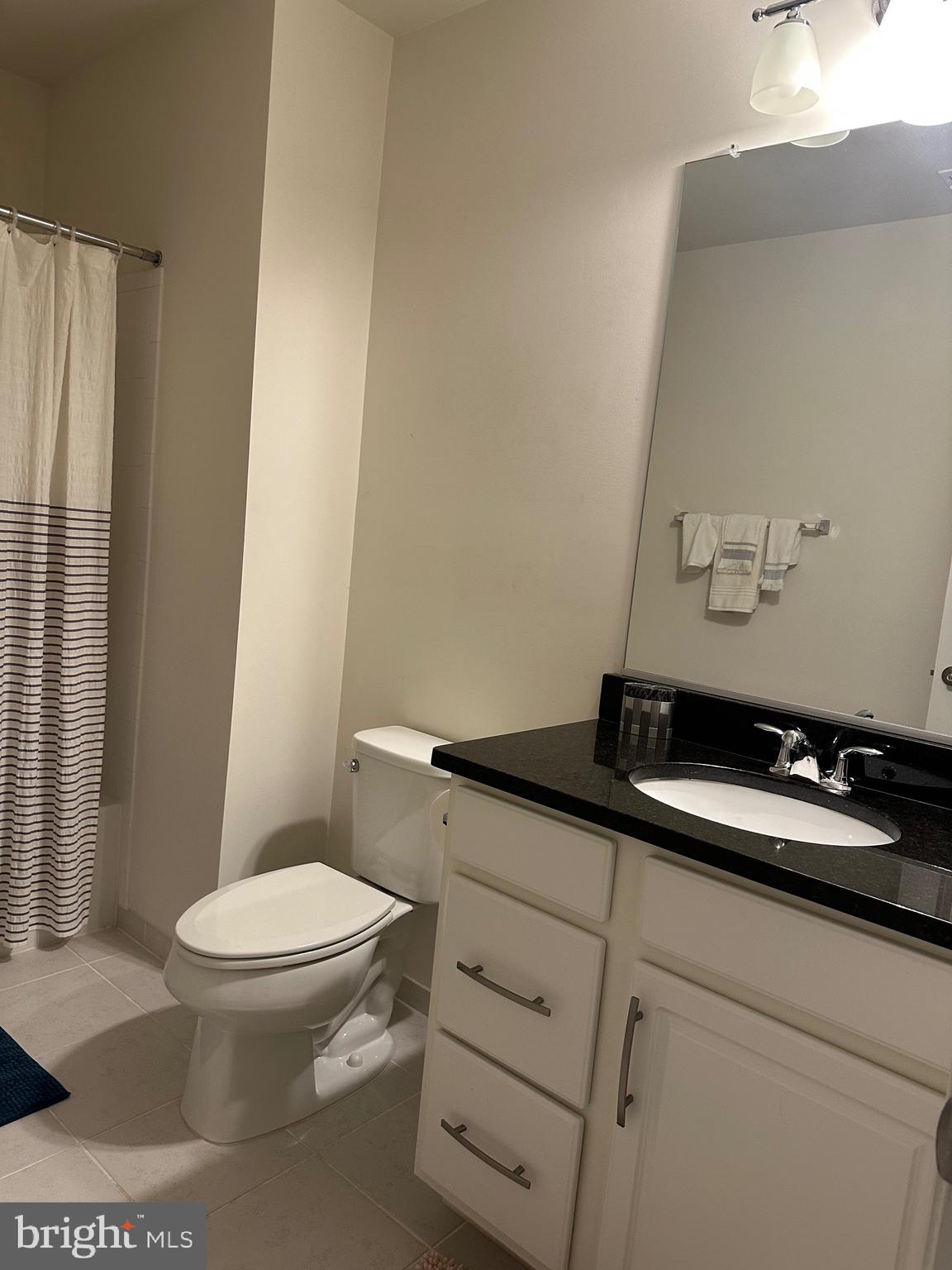 24800 Beardgrass Place Aldie, VA 20105 - Photo 24 of 25 a bathroom with a granite countertop toilet sink and mirror