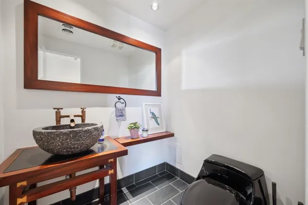 a bathroom with a sink a mirror and vanity
