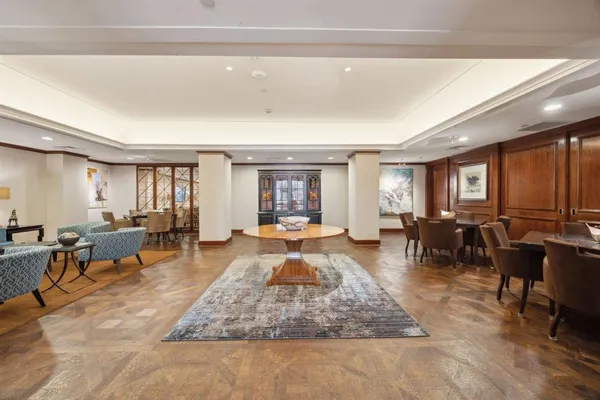 a living room with furniture large window and table