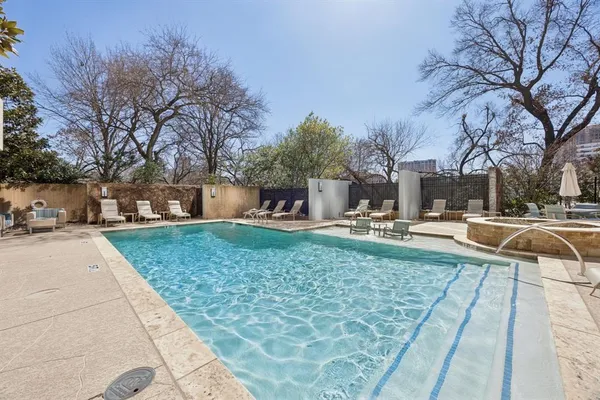 a swimming pool with outdoor seating and yard