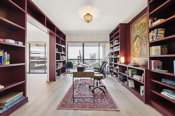 a living room with furniture and a book shelf