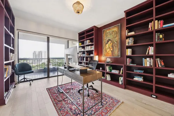 a living room with furniture and a book shelf