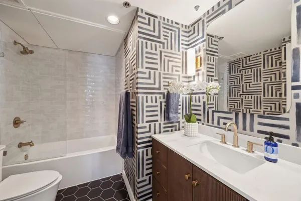 a bathroom with a sink a toilet and bathtub
