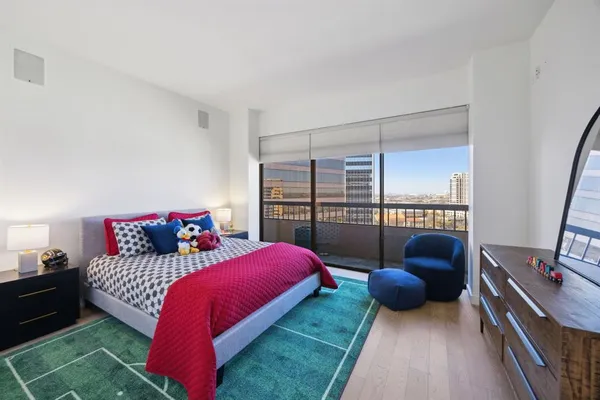 a bedroom with a bed couch and a window
