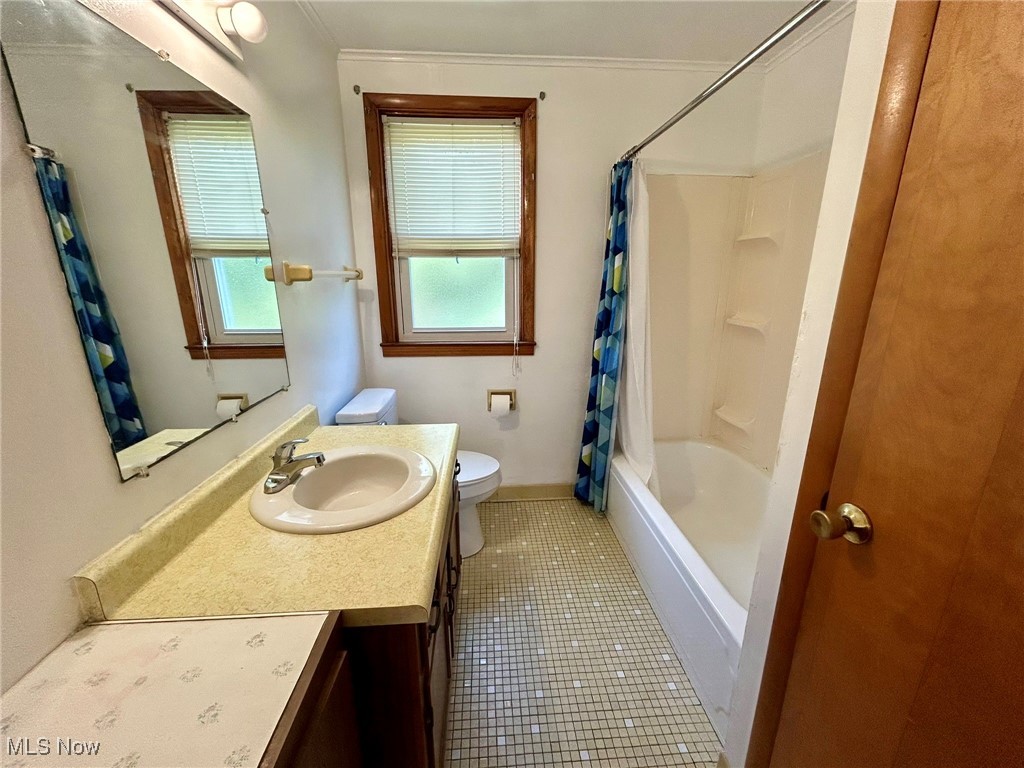 164 Locust Lane Follansbee, WV 26037 - Photo 11 of 19 Bathroom featuring shower / bathtub combination with curtain, vanity, dark tile patterned flooring, and crown molding