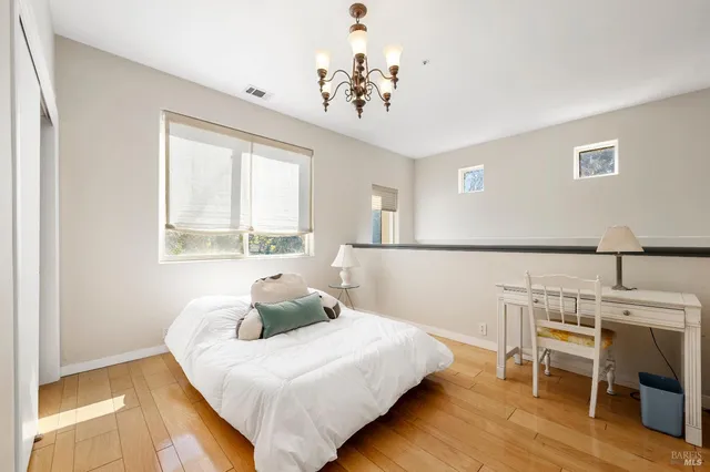 a bedroom with a bed and a chandelier