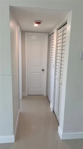 a view of a room with a white door